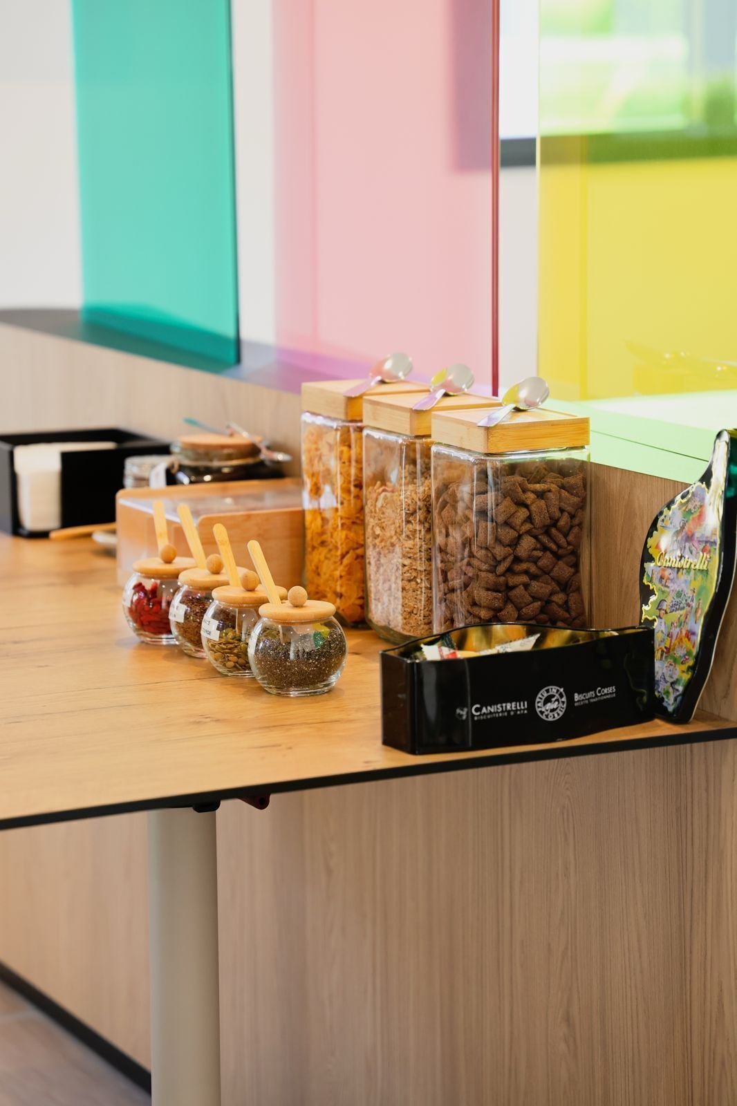 A counter with various food items, including jars of spices and a box of biscuits.