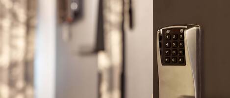 A modern door with a numeric keypad lock.