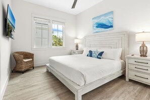 A bedroom with a bed, a nightstand, a lamp, a wicker chair, and a window with blinds. - 5 BR NEW 2026 BUILD | 5 O'Clock Shadow | Gulf Views | Sleeps 12 (Inlet Beach)