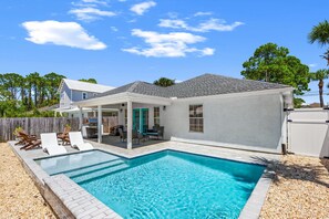 A residential property with a swimming pool, a covered patio, and a fenced backyard. - Paradise Palms! Quiet West End PCB Retreat! Walk to Beach! Sleeps 8! (Panama City Beach)