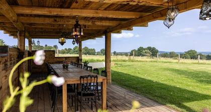 A historic farm nestled amid a breathtaking hilly landscape.