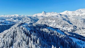 Un paysage de montagne enneigé, sous un ciel dégagé.