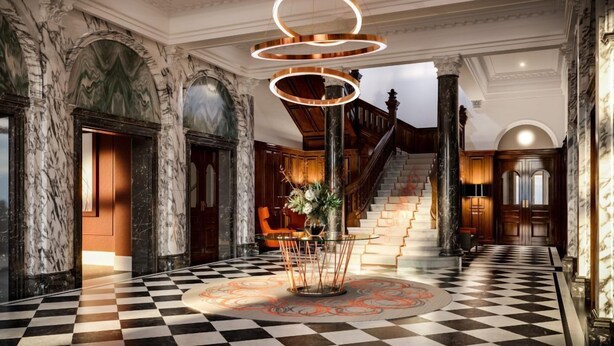 A grand lobby with marble walls, a checkered floor, a staircase, and a modern light fixture. - Clayton Hotel St Andrew Square, Edinburgh (Edinburgh)