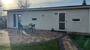 A single-story building with a patio area, a door, and a window. - Holiday Home in Velsen-zuid With Terrace (Velsen-Zuid)