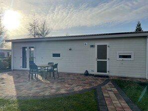 A single-story building with a patio area, a door, and a window. - Holiday Home in Velsen-zuid With Terrace (Velsen-Zuid)