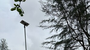 A park with outdoor seating, a lamppost, and a view of the sea. - 2-bedroom house 170 metre Seaview Homestay enchanting Mersing with swimming pool (Mersing)