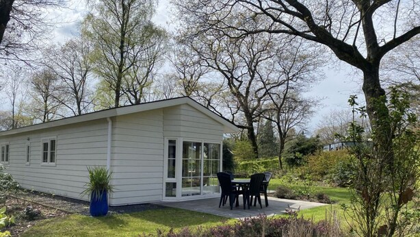 A single-story house with a patio, surrounded by a garden and trees. - Holiday Home in Otterlo With Terrace (Otterlo)