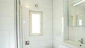 A modern bathroom with a toilet, a sink, and a mirror. - Holiday Home in Otterlo With Terrace (Otterlo)