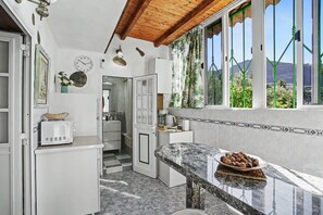 A kitchen with a microwave, a toaster, and a plate of cookies on the counter.
