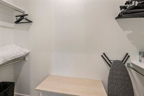 A small, narrow room with a wooden bench, a white wall, and a black towel hanging on a hook. - Villa 4 at Troon North, Luxury Golf Retreat with Pool Table (Scottsdale)