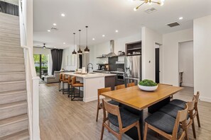 A modern kitchen with a central island, stainless steel appliances, and pendant lighting. - Villa 4 at Troon North, Luxury Golf Retreat with Pool Table (Scottsdale)