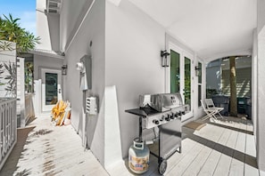 A patio with a barbecue grill, outdoor furniture, and a trash bin. - NEW LISTING - Completely remodeled with new pics coming soon. (Seacrest Beach)