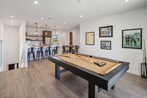 A pool table in a modern room with a bar area and dining space. - Villa 1 at Troon North, Luxury Golf Retreat with Pool Table (Scottsdale)