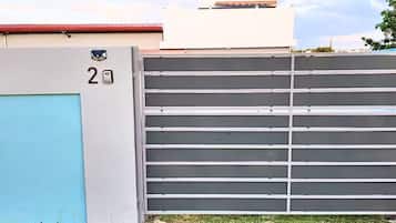 A gated area with a number '2' sign, a blue door, and a metal gate.