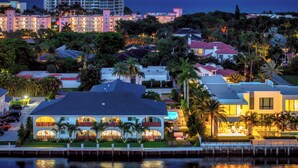 A coastal hotel with multiple buildings, a marina, and palm trees. - Villa Sirena: Boca Waterfront Escape (Boca Raton)