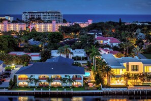 A coastal hotel with multiple buildings, a marina, and palm trees. - Villa Sirena: Boca Waterfront Escape (Boca Raton)