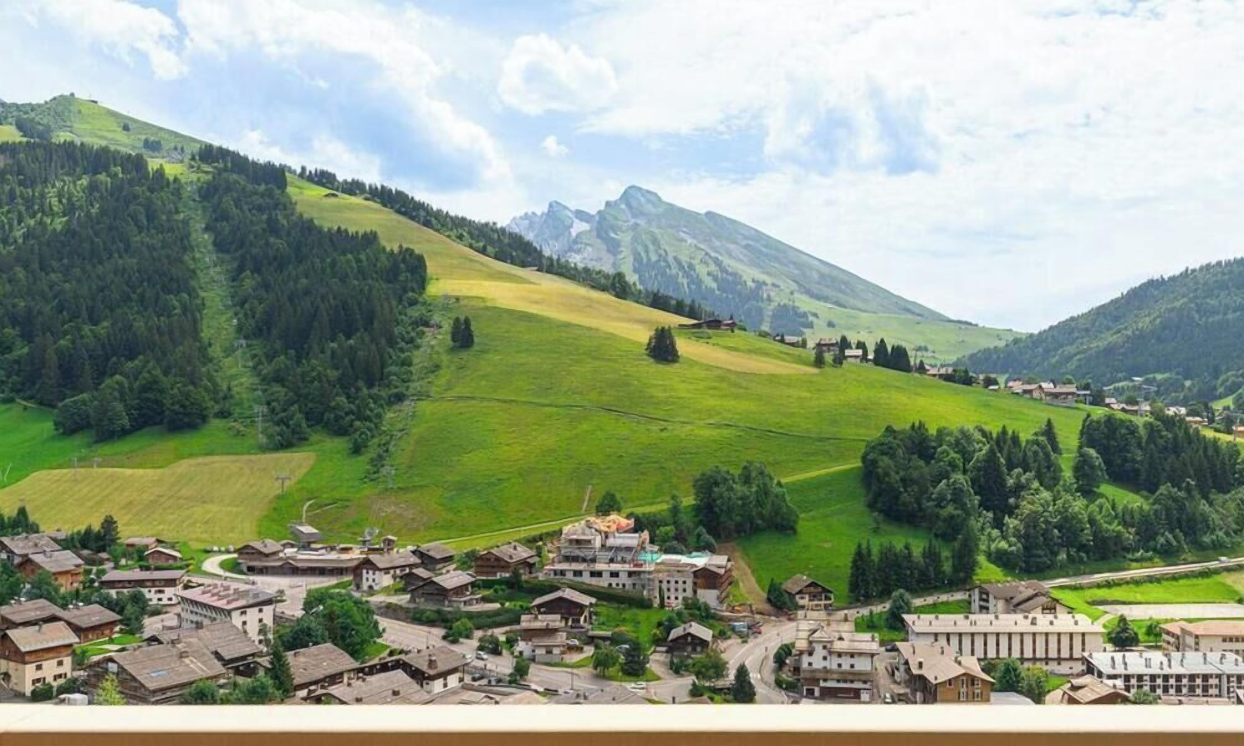 A mountainous landscape with a village and buildings.
