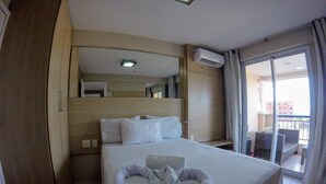 A hotel room with a bed, a small balcony, and an air conditioning unit. - Beach Village sea View 2 Bedrooms (Fortaleza)