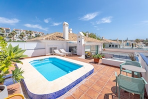 A rooftop pool with a tiled edge, lounge chairs, and a seating area. - Arkadia – Beachfront Penthouse with Private Pool (Mijas Costa)