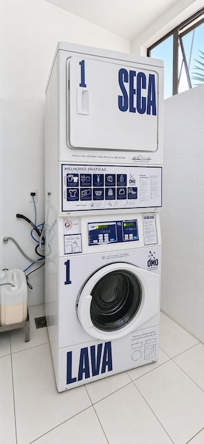 A front-loading washing machine with a control panel and a detergent dispenser.