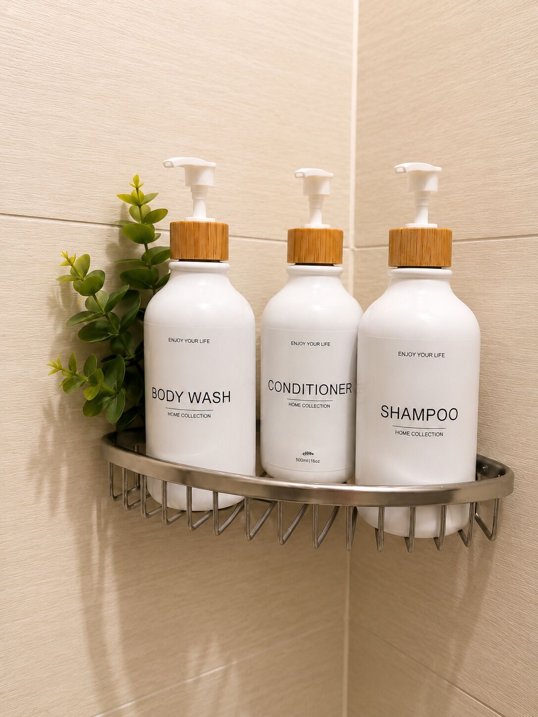 Three white bottles with wooden caps on a metal shelf against a tiled wall.