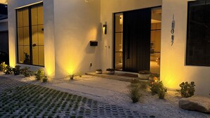 A modern house with a paved driveway, a large window, and a door. - Bali-inspired Oasis in the Heart of Winter Park (Winter Park)