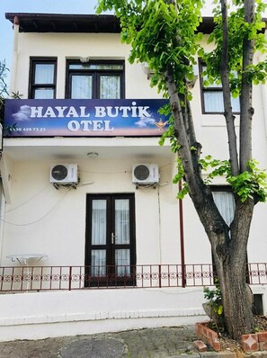 A two-story building with a sign for 'Hayal Butik Hotel' and two air conditioning units on the exterior wall. - Hayal Butik Otel (İstanbul)