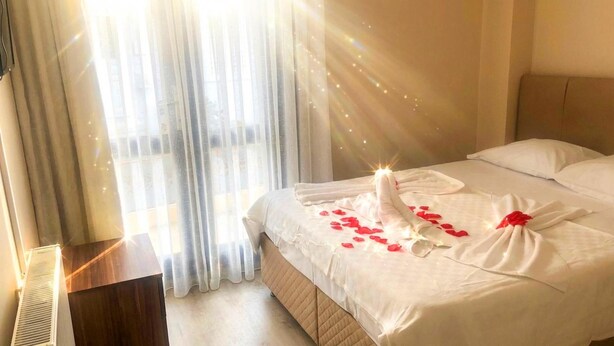 A hotel room with a bed, curtains, and a window. - Hayal Butik Otel (Adalar)