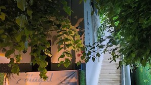 A staircase leading to a building with a banner reading 'Hayal Pansiyon' and a blue mat at the bottom. - Hayal Butik Otel (Adalar)