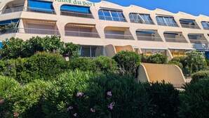 A hotel with a unique architectural design, featuring multiple balconies and a prominent sign. - Sol-y-Days Jardins du port large terrace and swimming pool (Le Grau-du-Roi)