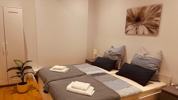 A double bed with two pillows, a bedside table, a lamp, and a wall-mounted artwork. - Eli and Eli 1 Vacation Rental in the Heart of Berlin / Near Alexanderplatz (Berlin)