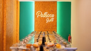 A foosball table in a room with a green wall and a wooden panel. - Palhoça Hotel  (Canindé)