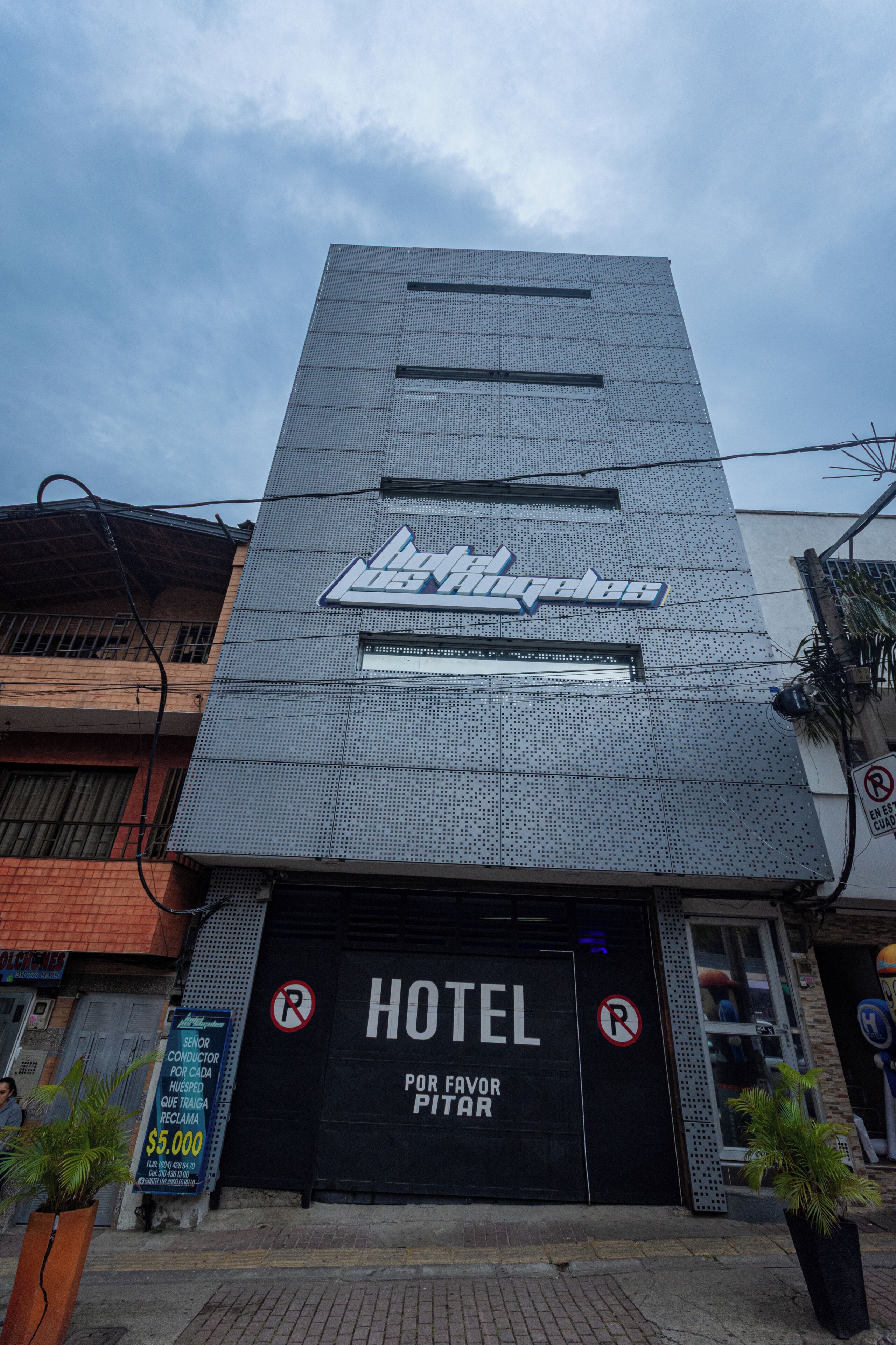 A hotel with a prominent sign, a large garage door, and a signboard advertising senior discounts.