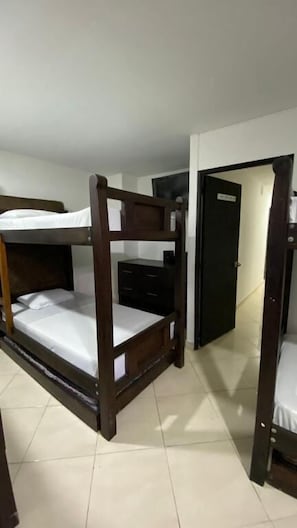 A bunk bed with a wooden frame and a dresser.