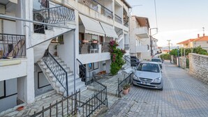 A residential building with a staircase, balconies, and a parked car. - Dimitra Home by Rentals Pro - Polychrono Halkidiki (Polychrono)