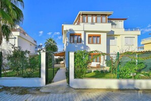 A two-story house with a gated entrance, a covered porch, and a well-maintained garden. - Villa Esma - 3 Bed with private garden (Antalya)