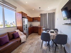Un apartamento moderno con cocina, comedor y sofá.
