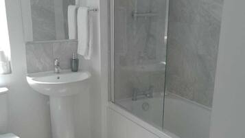Shower, hair dryer, towels, shampoo