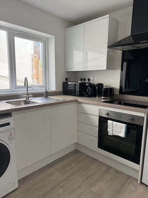 Fridge, microwave, oven, stovetop - Ground Floor Flat with Courtyard garden (Weston-super-Mare)