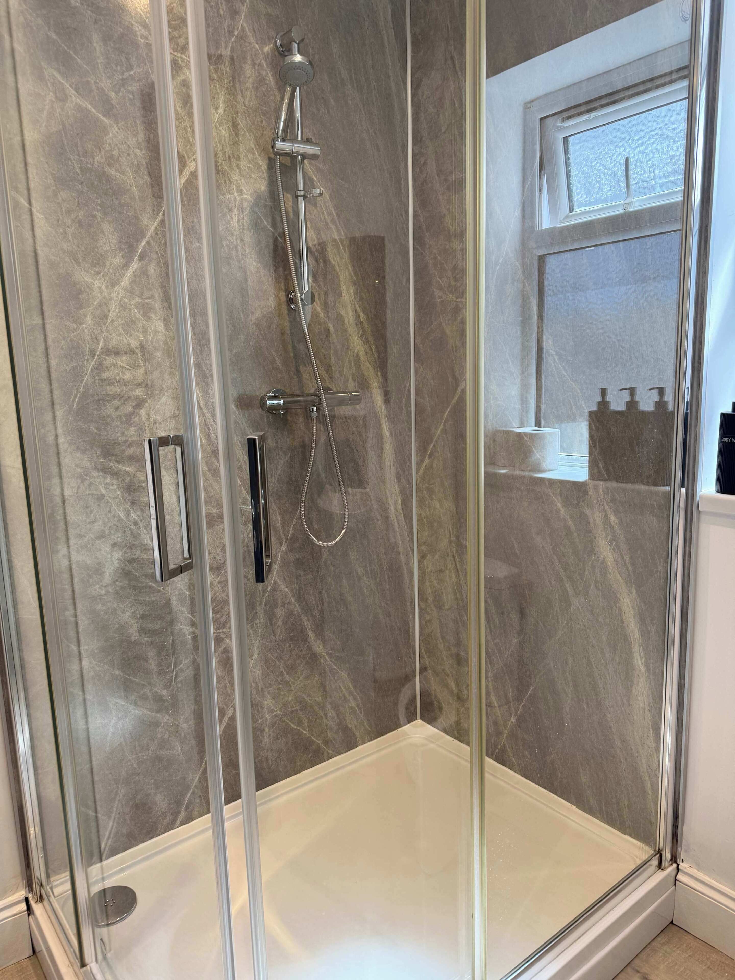 Shower, hair dryer, towels, shampoo