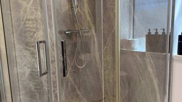 Shower, hair dryer, towels, shampoo