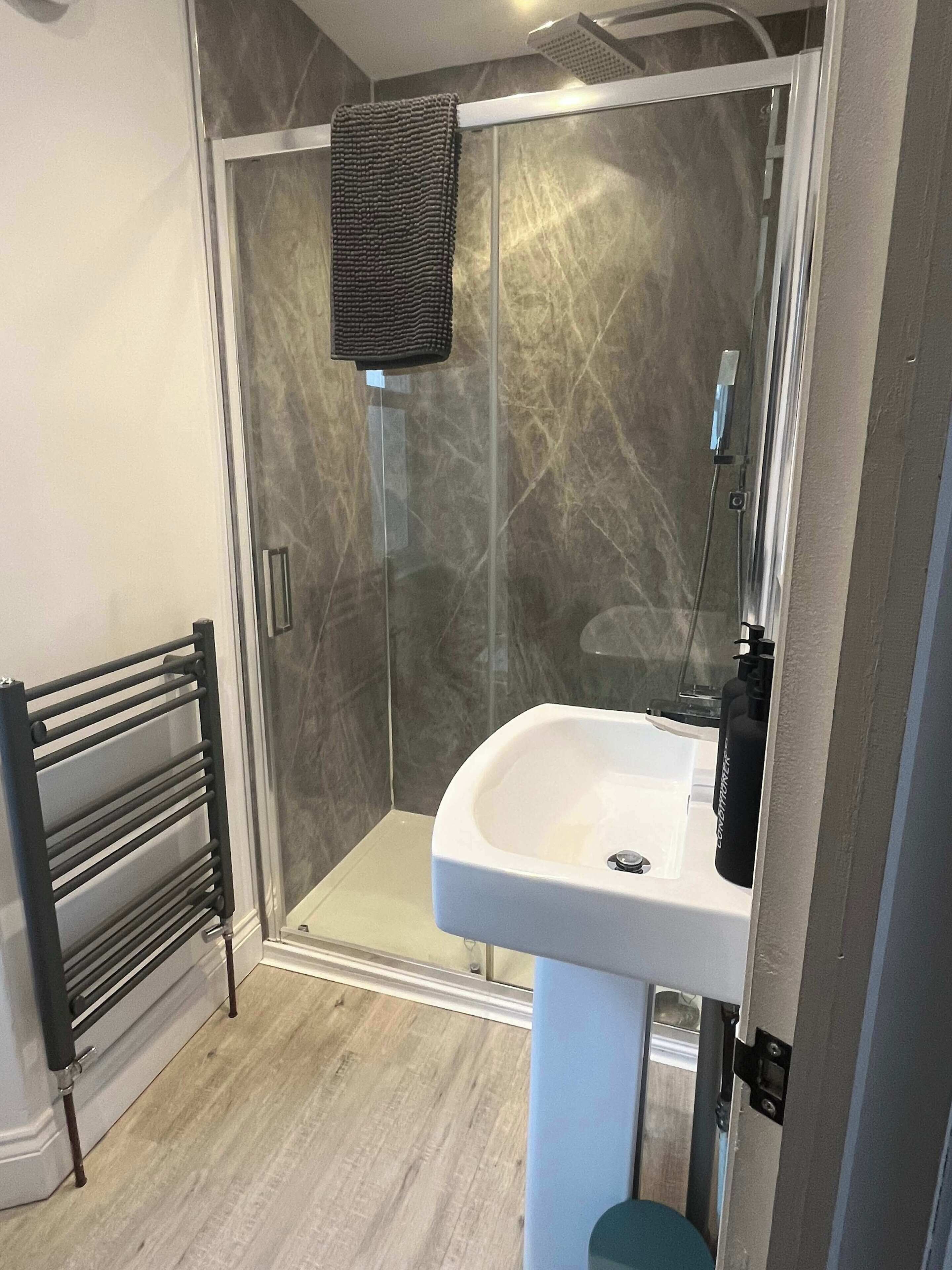 Shower, hair dryer, towels, shampoo