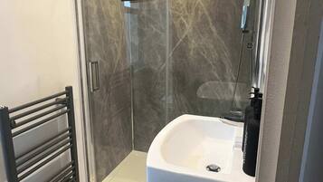 Shower, hair dryer, towels, shampoo