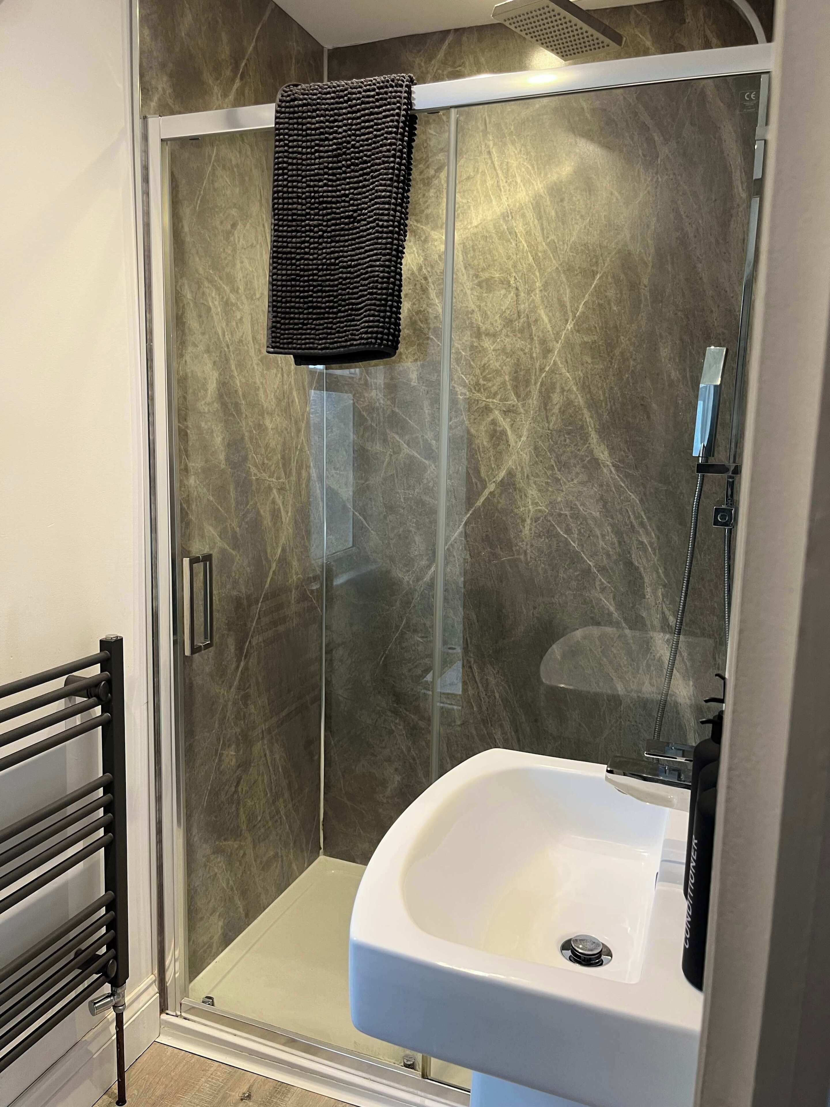 Shower, hair dryer, towels, shampoo