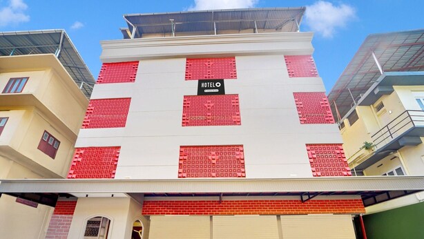 Et hotel med et skilt, der siger 'HOTEL', og en facade i rødt og hvidt.