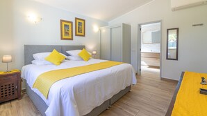 A hotel room with a bed, bedside table, lamp, and a view of the outside. - Villa Dean Private Pool For Families AC WI- (Lagos)