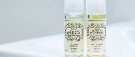 Two bottles of 'Aroma de Portugal' shampoo and bath gel on a white surface.