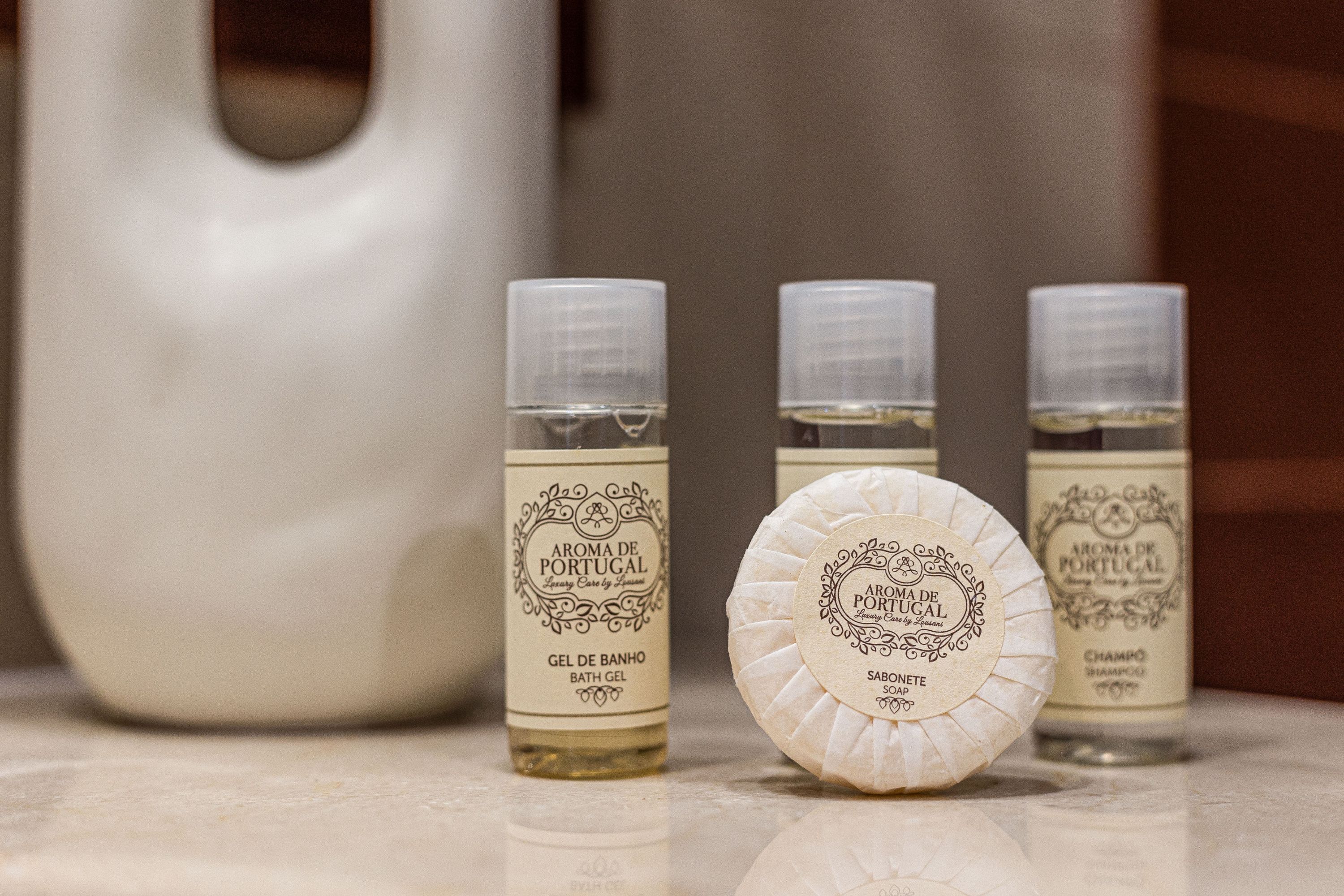 Three bottles of 'Aroma de Portugal' bath gel and a bar of soap.