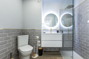 A modern bathroom with a toilet, sink, and shower. - Pateo da Rocha in Portim o (Portimão)