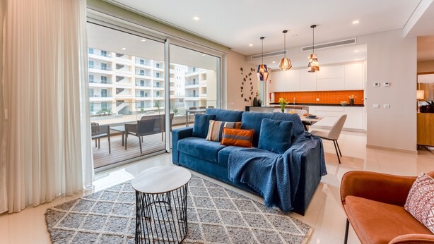 A modern living room with a sofa, a coffee table, and a dining area. - Adega Luxury Near Lagos City Center With Pool (Lagos)